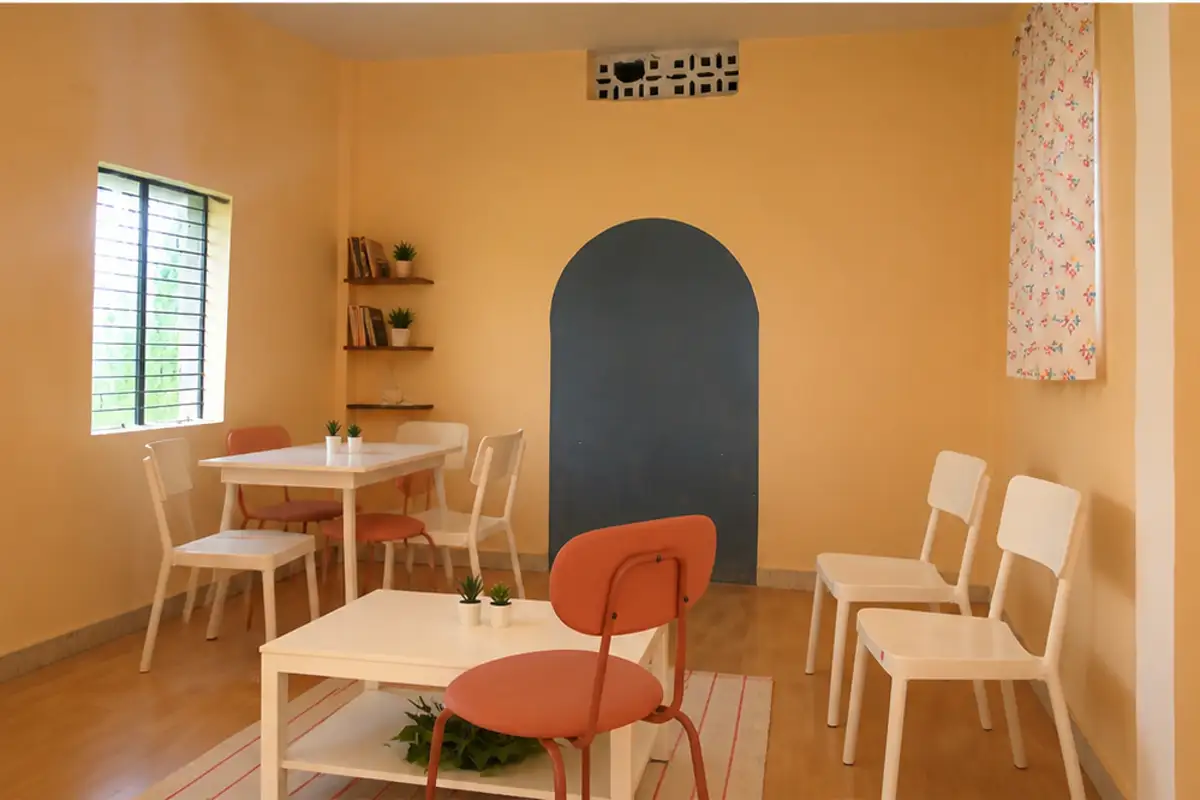 The Dongri library after furnishing, with reading tables, chairs and warm painted walls