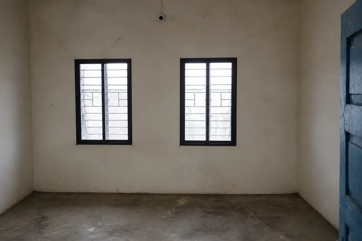 The Kachurwahi room before renewal, with bare walls, windows and an unfinished floor
