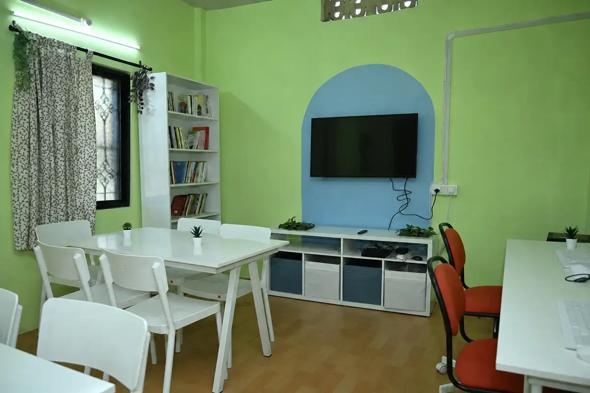 The Wadamba library after renewal, with bookshelves, tables, computers and refreshed blue arches